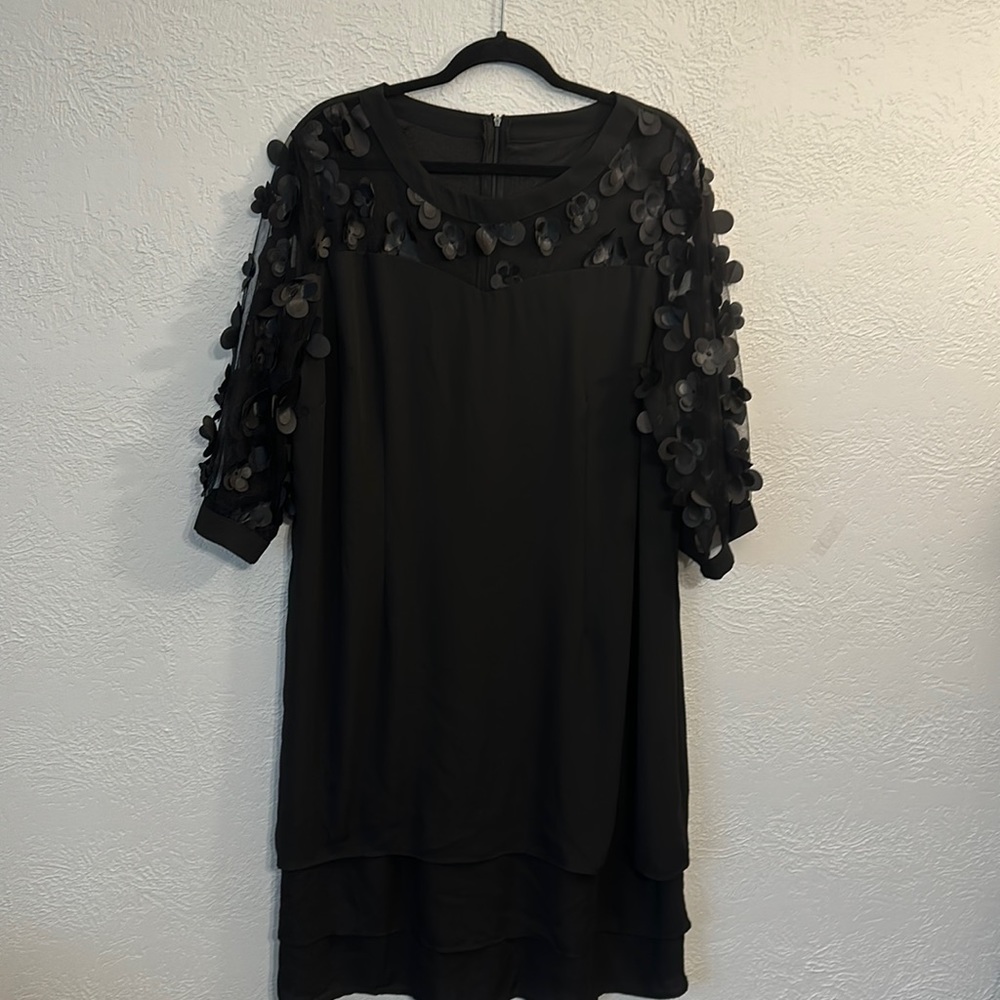 Black shift dress with flowers that are dimensional.